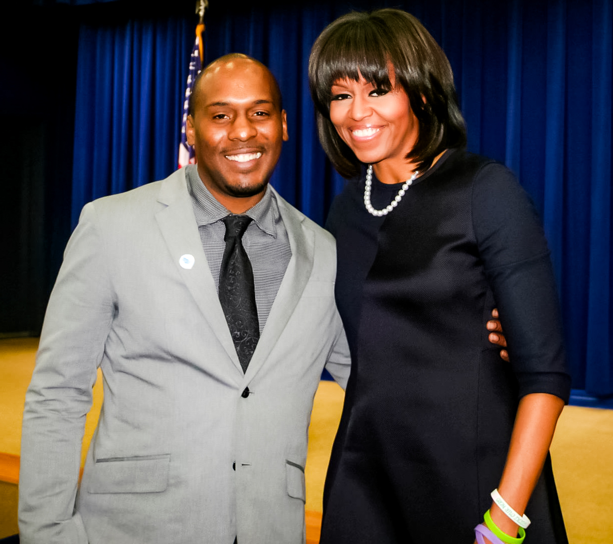 Chris Foye standing with First Lady Michelle Obama at the White House, 2013